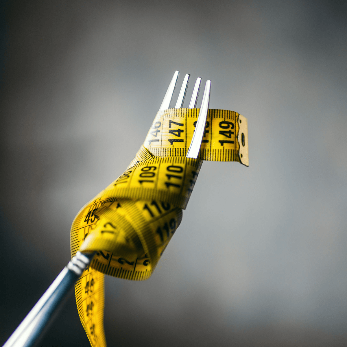 Picture of a tape measure wrapped around a fork